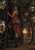 A woman in a burgundy gown stands on black carriage steps beside a leafy tree hung with reflective globes at sunset.