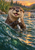 Front-facing river otter holding a silver fish in choppy teal water with orange sunset reflections and a riverbank behind it.