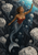 Mermaid swimming upward through a dark columnar underwater chasm toward turquoise light, surrounded by pale porous masses.