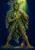 A leafy, bark-faced olive-tree guardian holds golden olives beneath green light, with a terracotta jar at its feet.
