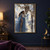A woman in a flowing blue gown holds a sheer veil beside a towering antlered stag above reflective water.; frame shown for styling only