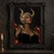 Close portrait of a dark-skinned woman with pale curls, segmented gold horns, and pointed gold-edged shoulder armor.; frame shown for styling only