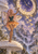 Pink-haired fairy with patterned translucent wings reaches toward a large clock as golden birds fly over mushrooms, waterfalls, and ruins.
