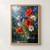 Rain-beaded bouquet of red poppies, blue irises, white cosmos, and grasses in a dark vessel against a softly lit garden.; frame shown for styling only