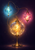 Three glowing glass lamps in cyan, amber and magenta form a triangle against a dark violet background, joined by copper-colored loops.
