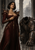 Dark-haired woman in a deep red gown beside kneeling empty armor in a ruined stone hall with arches and a distant landscape.