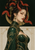 A horned woman in green and gold with red snakes winding through her black updo and a gold disk behind her head.