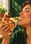 Person with closed eyes biting a margherita-style pizza slice, held from beneath, with melted cheese and kitchen light.