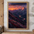 A rose-gold-lit mountain peak rises above a dark alpine valley as a reflective river winds toward a low sunset beneath storm clouds.; frame shown for styling only