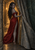 Pointed-eared woman in a red gown holding a massive stone curtain in a torchlit arched corridor.
