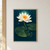 A white water lily with a yellow-orange center rises above three broad floating leaves, ripples, and droplets on a dark teal background.; frame shown for styling only
