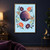 Purple-and-coral ringed planet with a small round moon, six coral and aqua flowers, curling green foliage, and golden stars on light blue.; frame shown for styling only