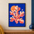 Warm coral-like branching form with a partly hidden orange disk and small oval against vivid blue, with TIDAL BLOOM lettering at the bottom.; frame shown for styling only