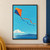 Orange-and-indigo diamond kite with curling ribbon tails flying over turquoise sky, distant hills, and water.; frame shown for styling only