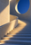 Pale concrete staircase and curved rail rise toward a large circular opening filled with deep blue sky, crossed by warm sunlight and cool shadows.