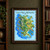 Illustrated invented island map titled Island of Wind and Wild Gardens, with a blue coastal current, mountains, walled garden, harbor, and patterned border.; frame shown for styling only