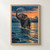 Elephant wading through an indigo river at dusk, raising its trunk as water sprays beneath a coral-orange sky.; frame shown for styling only