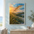 A golden feathery dune-grass stalk arches above dense grasses, with a narrow strip of ocean beneath a glowing apricot and teal sky.; frame shown for styling only
