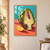 Lengthwise-cut artichoke with green and violet bracts beside a lemon wedge on a coral tabletop, against a turquoise wall.; frame shown for styling only