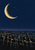 Warm-gold crescent and three star-like marks above a tilted dark rooftop grid, with a muted violet horizon on an ink-blue background.