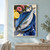 Silvery fish arranged diagonally in a deep blue dish beside a lemon half, pink blooms, and indigo cloth.; frame shown for styling only
