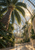 Towering palm beneath an arched glass conservatory roof, with a curved walkway and sunlight reflecting on the atrium floor.