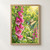 Turquoise-and-green hummingbird hovering beside a tall spike of pink foxglove flowers with speckled throats in a bright green garden.; frame shown for styling only