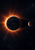 Blue Earth-like globe against an orange solar corona, with a smaller shadowed Moon-like body to the right and sparse stars.