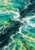 Abstract view of a dark green current twisting diagonally through turquoise water and white foam.