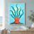 A coral-red anemone-like form with teal tentacles and a small orange fish above a textured seabed.; frame shown for styling only