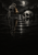 A skeletal hand holds a brass bell above dark rippling water beside a floating skull under a cloudy moonlit sky.