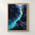 A turquoise river curves through tall dark angular cliffs toward a warm glow in the distance, with a small title along the bottom.; frame shown for styling only