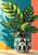Patterned green calathea-like leaves in a decorated cream pot against turquoise, coral, and yellow wall shapes.