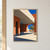 A modernist pavilion with a projecting roof frames a sunlit courtyard, leafy tree, and cobalt sky beyond an arch.; frame shown for styling only