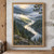 Winding river through a foggy pine-covered mountain valley, with an illuminated clearing, rocky foreground, and branches framing the view.; frame shown for styling only