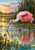 A pink roseate spoonbill wades in reflective marsh water with its long bill lowered near a ripple, reeds, and a colorful sunset sky.
