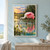 A pink roseate spoonbill wades in reflective marsh water with its long bill lowered near a ripple, reeds, and a colorful sunset sky.; frame shown for styling only