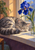 Sleeping silver-gray tabby curled on a windowsill beside a blue iris in a clear jar and leafy plant.