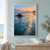 Reflective teal-blue shallows and a dark rock on a beach at dawn, with a hazy headland and apricot light near the horizon.; frame shown for styling only