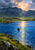 Small red canoe with a lone paddler on blue mountain water beneath a dark ridge and glowing apricot-pink clouds.