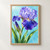 Violet-blue bearded iris covered in bright droplets, with a partly opened bud and long green leaves against an aqua background.; frame shown for styling only
