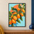 Diagonal branch of bright orange kumquats with glossy green leaves, a cut fruit, and a white blossom against pale aqua and coral.; frame shown for styling only