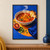 Cream bowl of red-orange broth with herbs and bread on the rim, beside a blood orange and folded cobalt napkin on a blue tabletop.; frame shown for styling only