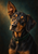 Close portrait of a black-and-tan hound with amber eyes, one tall upright ear and one floppy ear, wearing a dark green collar with a brass-colored charm.