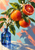 Citrus branch with whole oranges and one cut ruby-red orange, white blossoms, water droplets, and a cobalt-blue bottle.