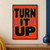 Black rounded capitals reading TURN IT UP, outlined in pale yellow, with a blue waveform on a vermilion background.; frame shown for styling only