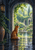A red-orange fox sits beneath a dark stone arch, facing a bright garden with foliage, flowers and reflective water.