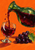 Green-tinted carafe pouring ruby-red grape juice into a short-stemmed glass beside dark grapes and a green leaf on orange.