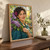 Smiling woman with short dark curls holding lilacs in a greenhouse, with a magenta flower tucked into her hair.; frame shown for styling only