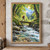 Adult hiker with orange backpack crossing a narrow bridge over a rocky stream beneath trees, with snowy peaks in the distance.; frame shown for styling only